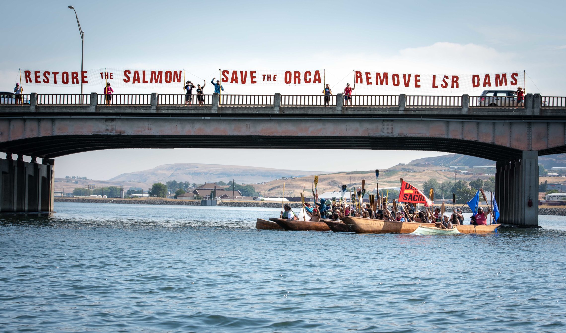 Tribal canoes and a message accross a tributary of the Snake River